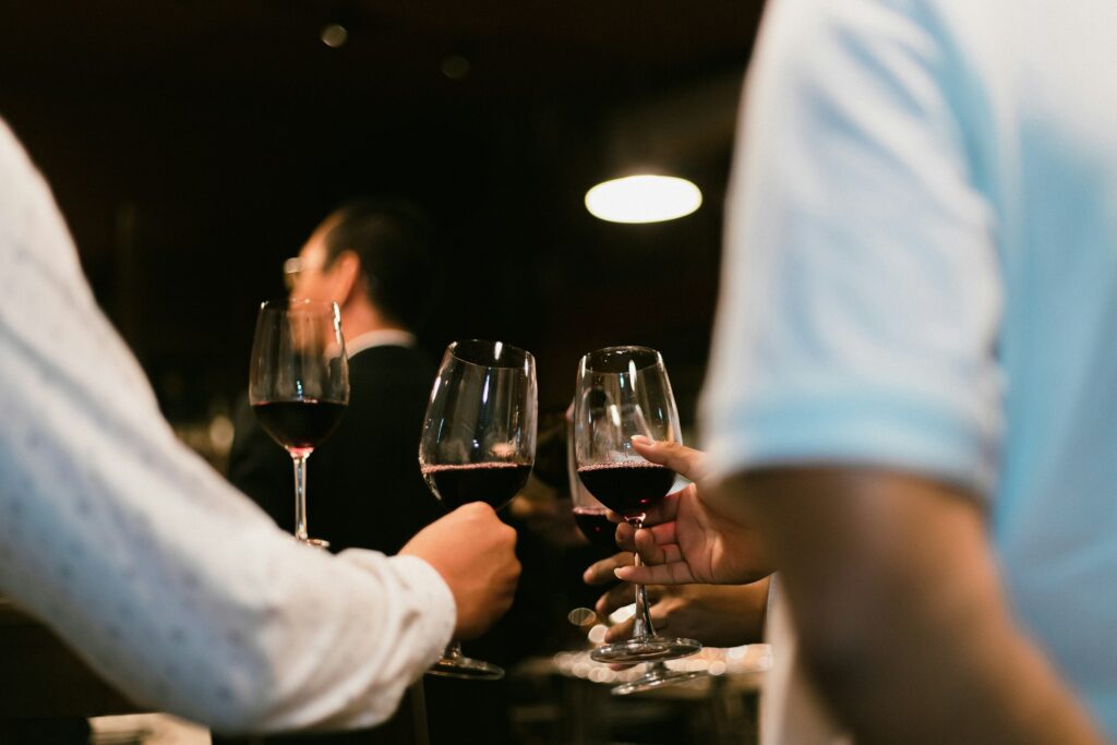 Friends experimenting with wine blending at home.